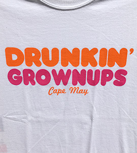 Drunkin' Grownups. Cape May. Text is in a rounded font, in orange and pink reminiscent of a major donut chain